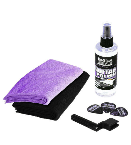 Guitar care kit with a spray bottle, microfiber cloth, and guitar picks on a white background