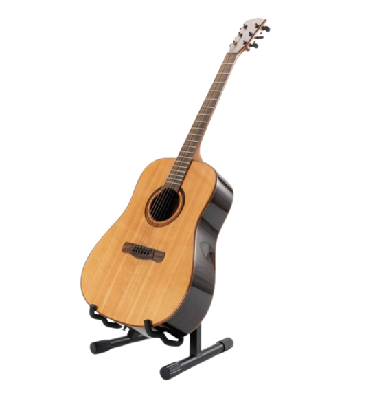 Acoustic guitar on a stand against a white background