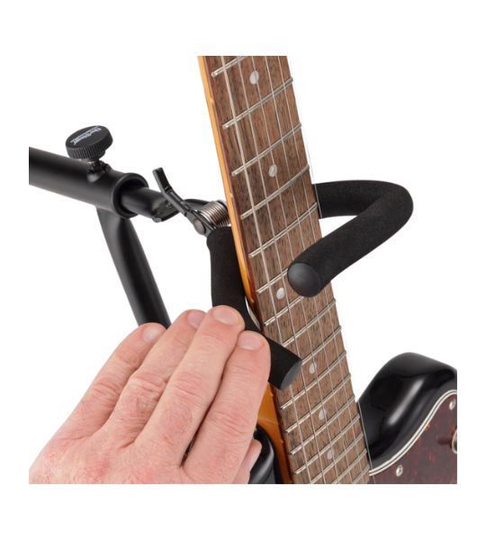 Guitar capo being used on a guitar with a white background